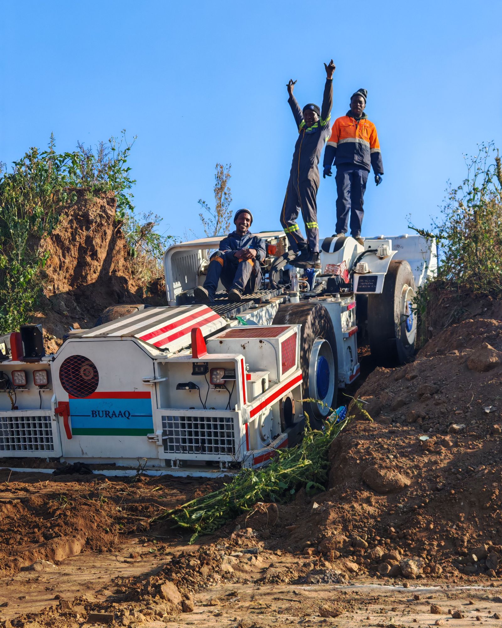 Miners on heavy machinery at a Southern African mining site